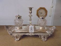 A silver Walker and Hall inkstand with central silver candlestick & glass inkwells with silver tops.
