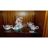 A USSR Russian pottery figure of a female with a frog and 4 small teapots (all missing lids)