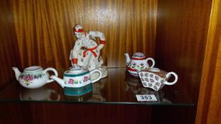 A USSR Russian pottery figure of a female with a frog and 4 small teapots (all missing lids)