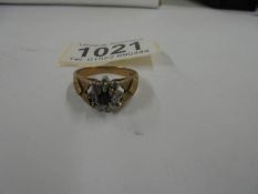 A 9ct gold cluster ring with central sapphire and diamond chips, size R half, 4.1 grams.