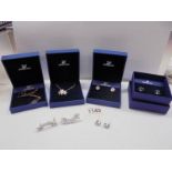Two boxed Swarovski crystal pendants, two boxed pairs of Swarovski earrings & 2 pairs of earrings.