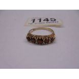 A ring set with five garnets in a graduated design, dated London 1981 in 9ct gold.