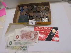 A mixed lot of old coins, four £1 notes and a 10/- note.