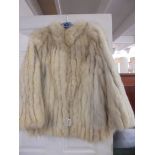 A good quality fur jacket, size 18.