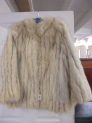 A good quality fur jacket, size 18.