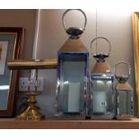 A set of 3 graduated candle lanterns & a brass bankers lamp. COLLECT ONLY