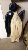 A large carved wooden wall plaque of a penguin, height 90cm, COLLECT ONLY
