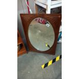 A circa 1920's mahogany framed oval bevel edged mirror in an oblong frame