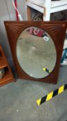 A circa 1920's mahogany framed oval bevel edged mirror in an oblong frame