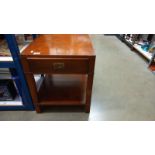 A dark wood stained table with brass corners and fittings plus a drawer