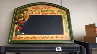 An advertising chalk board depicting fruit & veg