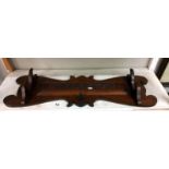 An arts & crafts oak gun/coat rack