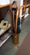 A brass umbrella stand & contents