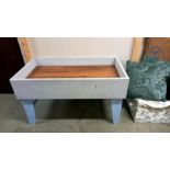 A raised bed for flower pots or a sand pit