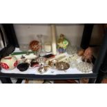 A shelf of miscellaneous candles & candle holders etc.