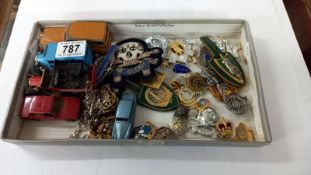 A quantity of military cap badges etc. Including some die cast Dinky