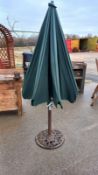 A garden parasol with cast iron base, COLLECT ONLY