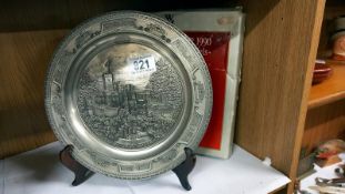 A boxed WMF plate with embossed castle scene.
