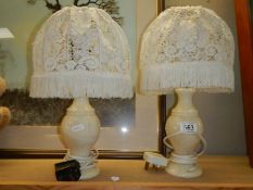 A pair of onyx table lamps.