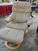 A cream leather reclining chair with matching stool, COLLECT ONLY.