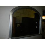 An arched top overmantel mirror in silver coloured frame, COLLECT ONLY.