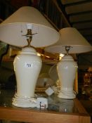 A pair of cream ceramic table lamps.