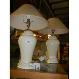 A pair of cream ceramic table lamps.