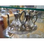 A silver plate teapot and water jug on tray.