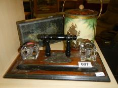 A vintage inkstand and two vintage tins.