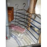 A quantity of fabric covered coat hangers and tie racks.