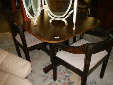 A dark oak dining table and four chairs. COLLECT ONLY.