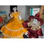 A vintage doll and a porcelain headed clown doll,.