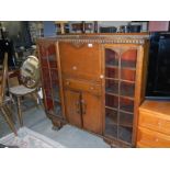 A 1930's oak side by side bureau bookcase, A/F 1 glass panel missing COLLECT ONLY.
