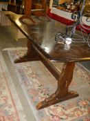 An Ercol dark oak dining table, COLLECT ONLY.
