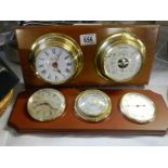 A ship's style wall clock with barometer on mahogany back and one other.