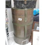 A large cylindrical military tin and one other.
