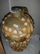 An E C Davies Gainsborough stoneware flagon covered in sea shells.