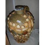 An E C Davies Gainsborough stoneware flagon covered in sea shells.