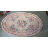 An oval rug depicting dragons - 123cm x 76cm at widest points, COLLECT ONLY