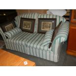 A good quality green striped two seat sofa, COLLECT ONLY.