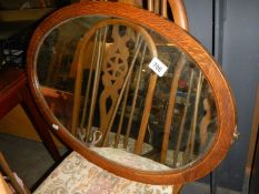 A 1930's oval oak framed mirror. COLLECT ONLY.
