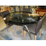 An oval glass top dining table and three chairs, COLLECT ONLY.