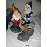 Two garden gnomes and a boot.