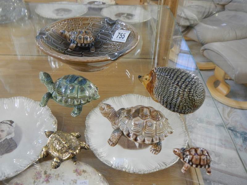A collection of Wade tortoises and a hedgehog trinket pot.