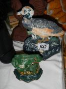 Two cast iron doorstops - duck and frog.