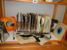 A retro 45 rpm record stand with records.