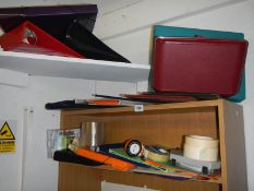 Three shelves of assorted office items.