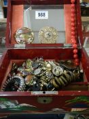 A lacquered jewellery box and contents.