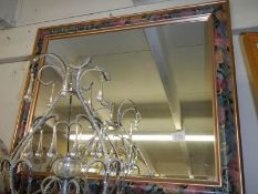 A bevel edged mirror in fancy coloured frame. COLLECT ONLY,.