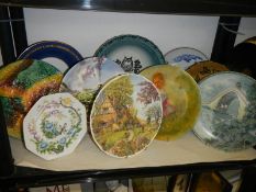 A shelf of assorted collector's plates.